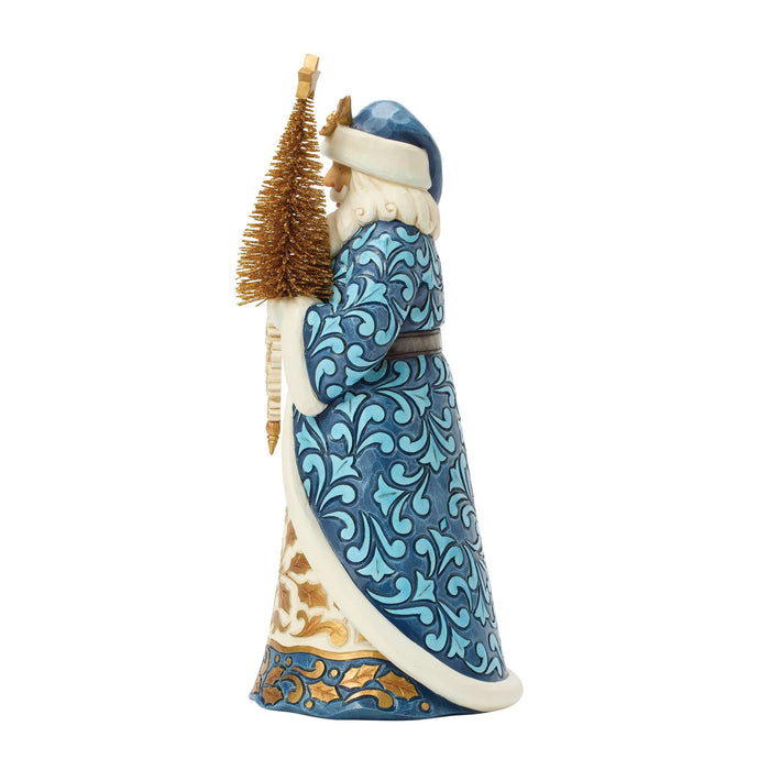Santa figurine with blue and gold accents holding a gold Christmas tree on a white background