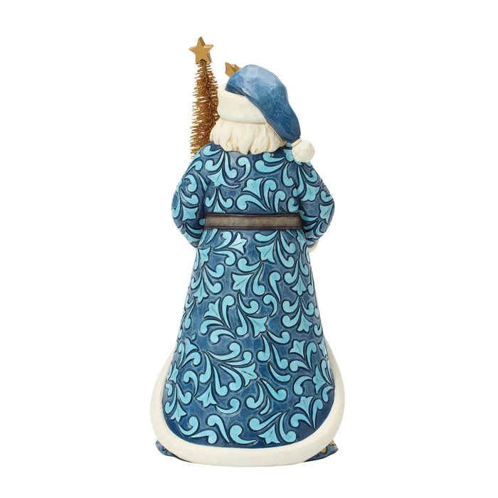 Santa figurine with blue and gold accents holding a gold Christmas tree on a white background