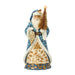 Santa figurine with blue and gold accents holding a gold Christmas tree on a white background