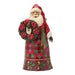 Festive Santa figurine holding a wreath with poinsettias on a white background