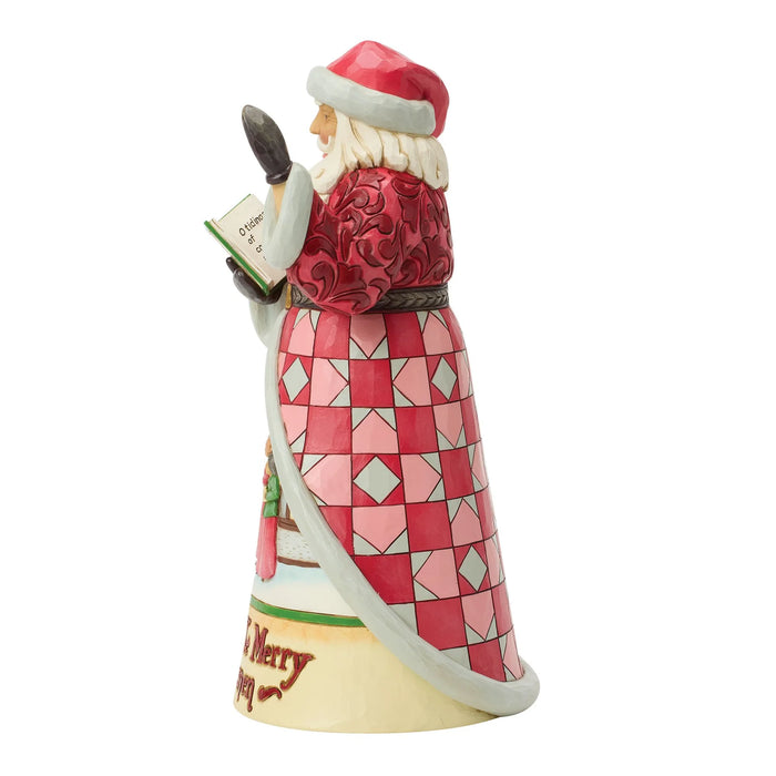 Santa Claus figurine with a book and Carolers scene on a white background