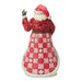 Santa Claus figurine with a book and Carolers scene on a white background