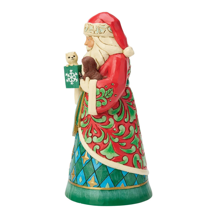 Decorative Santa figurine holding a puppy and a kitten on a white background
