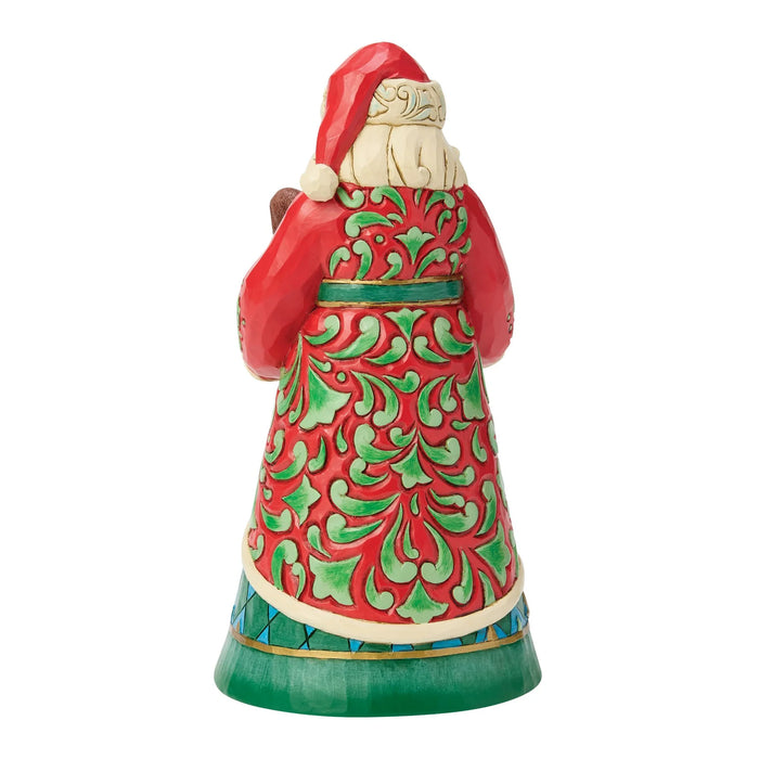 Decorative Santa figurine holding a puppy and a kitten on a white background