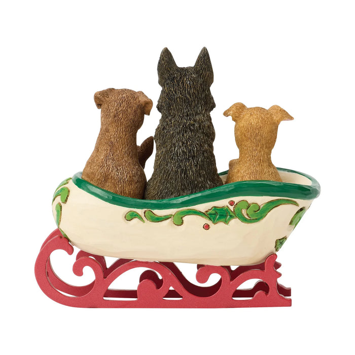 Decorative figurine of a sleigh with dogs inside on a white background