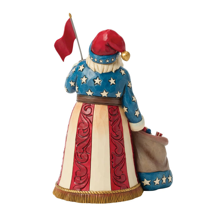 Decorative figurine of a patriotic Santa Claus holding an American flag on a white background