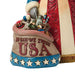Decorative figurine of a patriotic Santa Claus holding an American flag on a white background