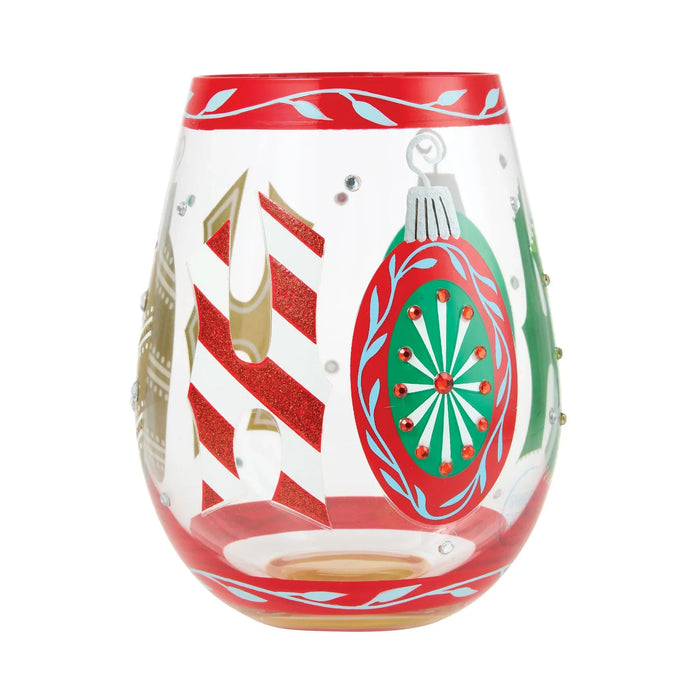Decorative wine glass with Christmas-themed design on a white background