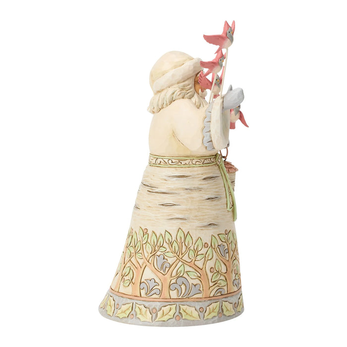 A decorative figurine of a Santa from behind wearing a birch-wood style dress and hat, holding a pink bird on a staff, shown against a plain white background.
