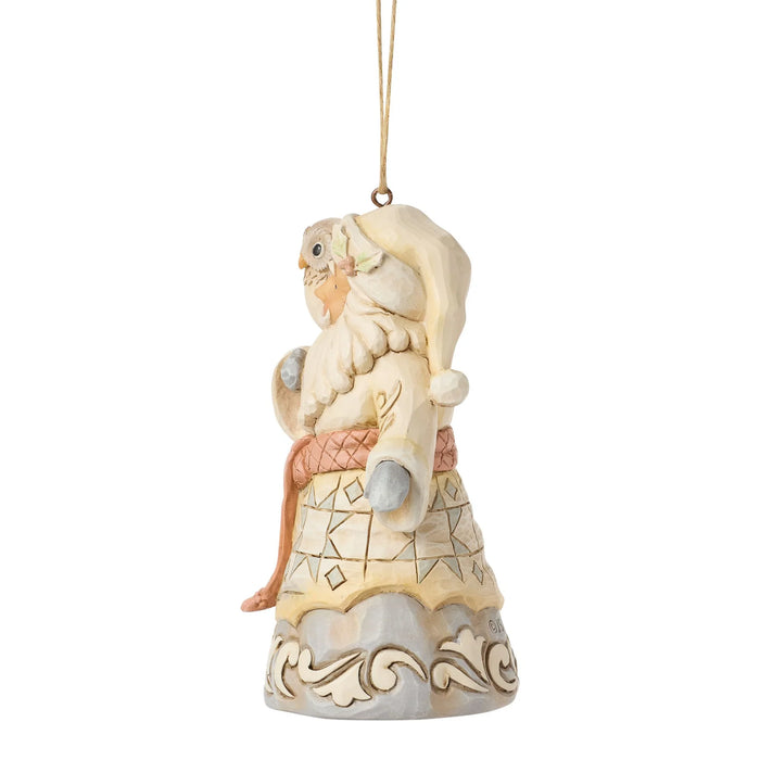 Ornament figure of Santa with an owl on his arm and a pink scarf that says '2026' on a white background