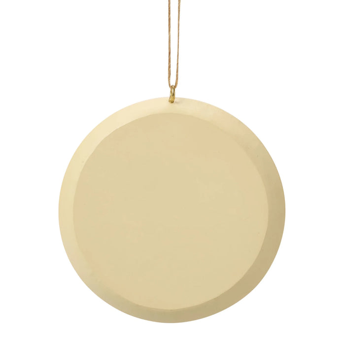 Round beige ornament hanging on a white background