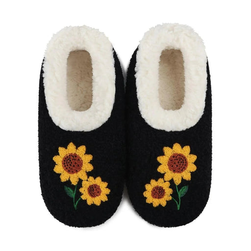 A pair of black slip-on slippers with white sherpa lining and embroidered yellow sunflowers on the front, shown against a plain white background.