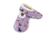 A pair of lavender purple fleece slipper socks featuring a playful print of various cartoon cats in different poses, with a soft cream sherpa lining visible at the opening, set against a plain white background.
