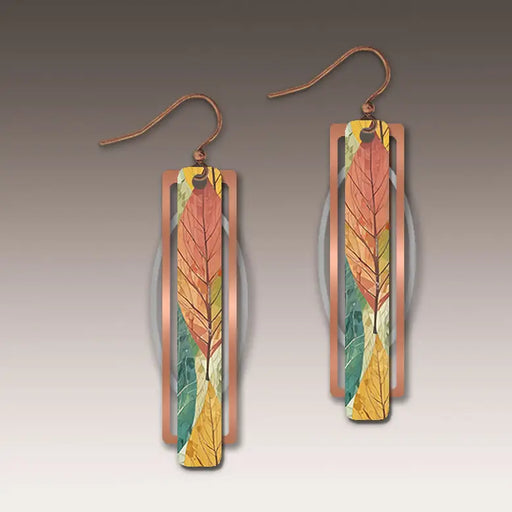 Pair of earrings with leaf design on a gradient background