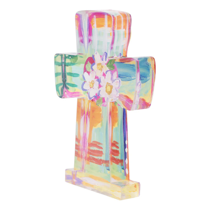 Colorful cross-shaped object with floral design on a white background