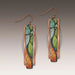 Mosaic-patterned earrings with copper frames on a gradient background