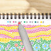Color swatch book with a pen on a wooden surface