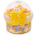 Toy container with a small plush toy inside, featuring colorful packaging and a yellow bow.