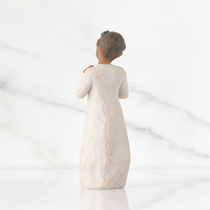 Statue of a woman in a flowing dress on a white background