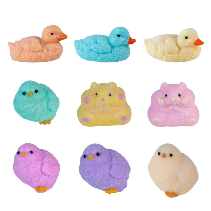 Set of colorful duck and chick figurines on a white background