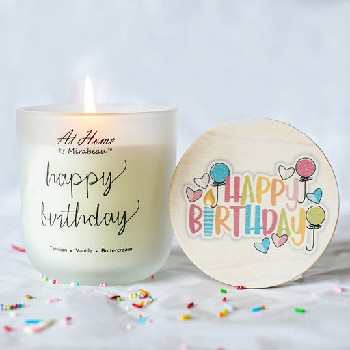 Candle with 'Happy Birthday' text and a decorative lid on a white background with sprinkles.