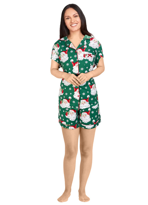 Woman wearing a festive green pajama set with Santa Claus pattern on a white background