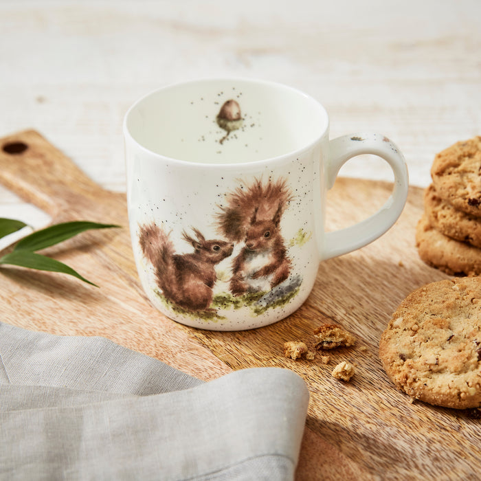 Mug with squirrel design on a wooden board with cookies