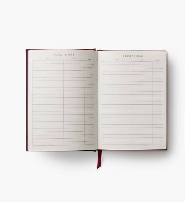 Open notebook with 'Books to Read' list on a white background