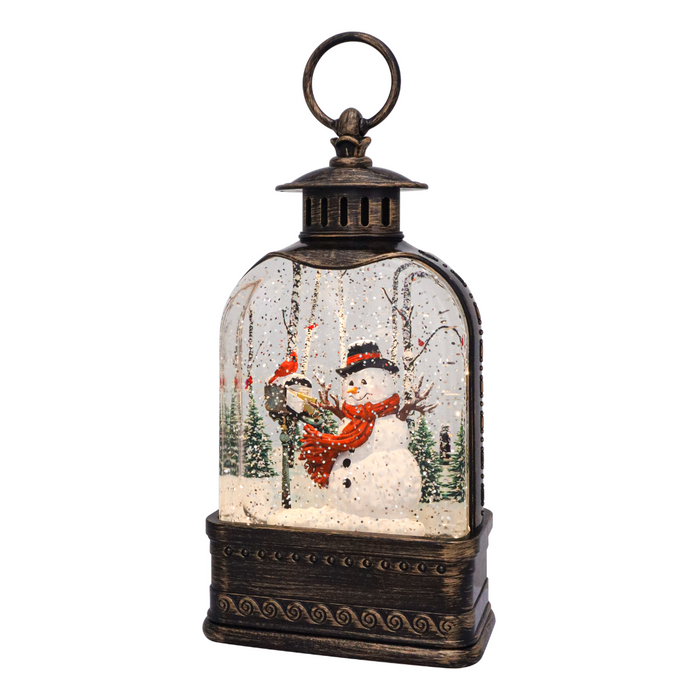 Decorative lantern with snowmen and a snowy landscape inside on a white background