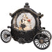 An ornate black and silver carriage-shaped snow globe featuring a couple in wedding attire inside, set against a plain white background.