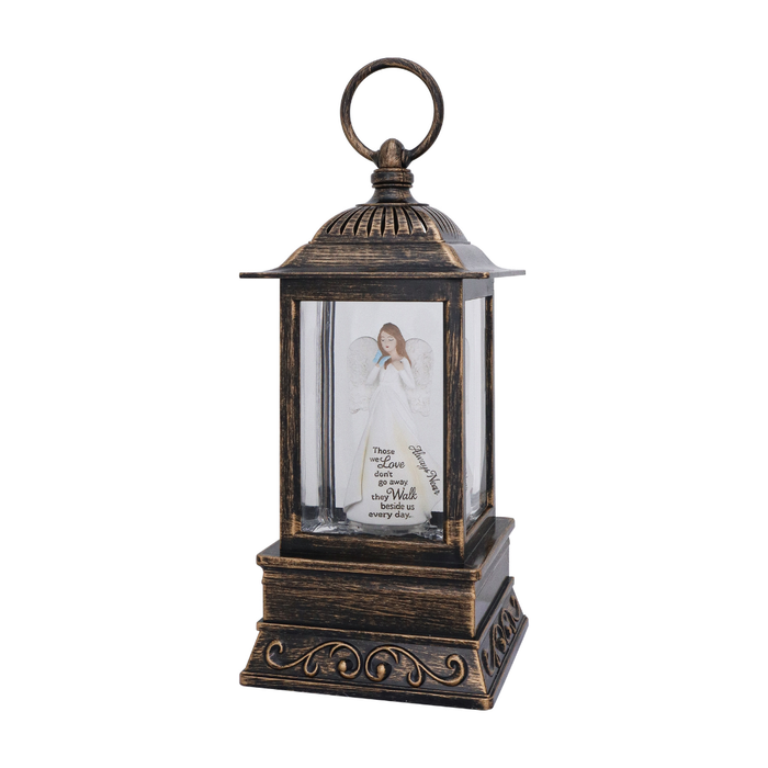 Decorative lantern with a glass panel featuring an angelic figure and text on a white background