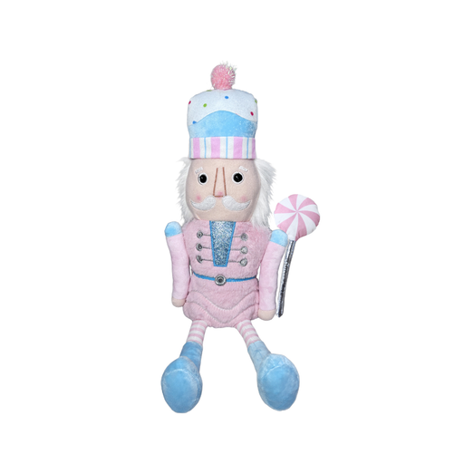 Plush toy resembling a nutcracker in pink and blue attire on a white background