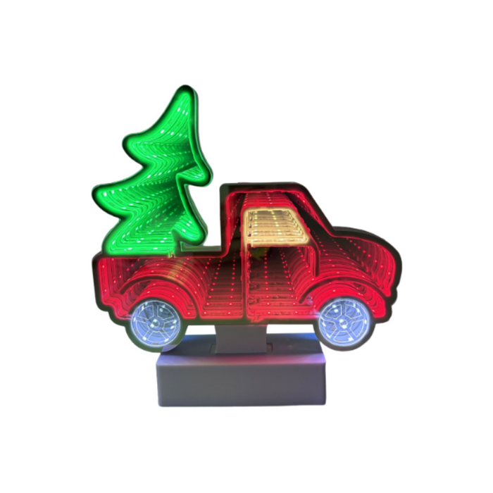 Decorative light shaped like a red truck with a green tree in the bed on a white background