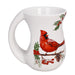 White mug with a red cardinal and holly design on a white background