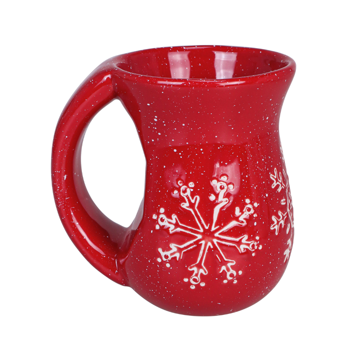 Red mug with white snowflake design on a white background