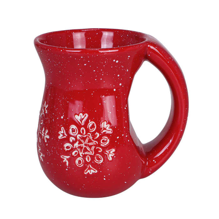 Red ceramic mug with white speckles and a snowflake design on a white background