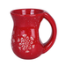 Red ceramic mug with white speckles and a snowflake design on a white background
