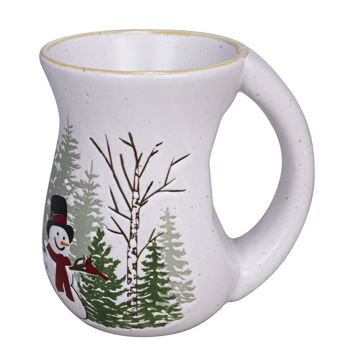 White mug with winter scene featuring trees and a snowman on a white background