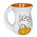White mug with orange interior, pumpkin, and leaf design on a white background