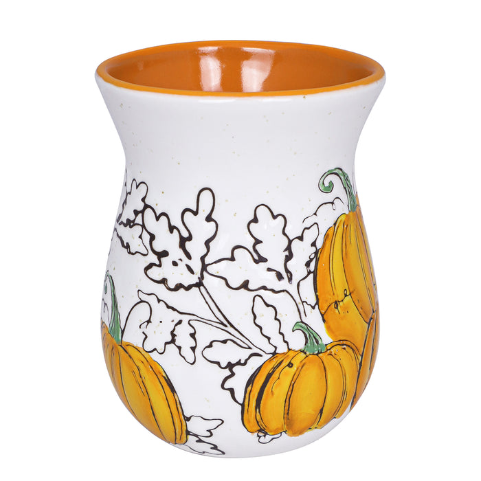 Ceramic mug with orange interior, white exterior, and black and orange pumpkin design on a white background