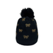 Black knit beanie with gold bows and a black pom-pom on a white background