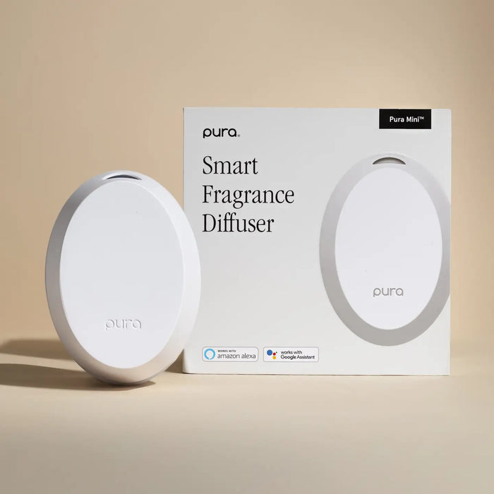 Pura Smart Fragrance Diffuser with packaging on a beige background