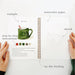 Open notebook with a green mug illustration, watercolor paper, and step-by-step instructions on a white background.