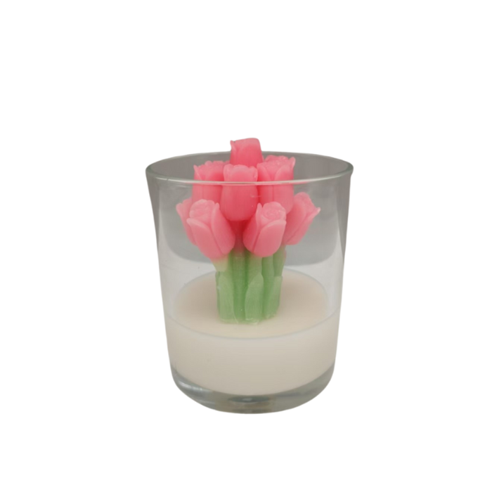 Glass candle holder with pink tulip-shaped candles on a white background