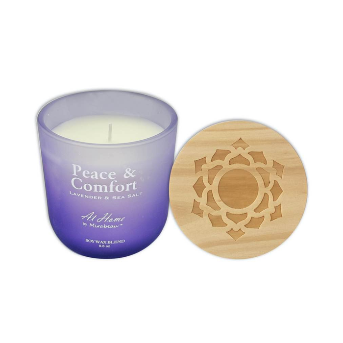 Candle with purple container and wooden lid on a white background