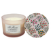 Candle with floral design lid on a white background