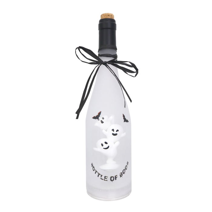 A frosted glass bottle with a black neck wrap and black ribbon bow, decorated with white ghost illustrations and the text 'BOTTLE OF BOO' on a plain white background.