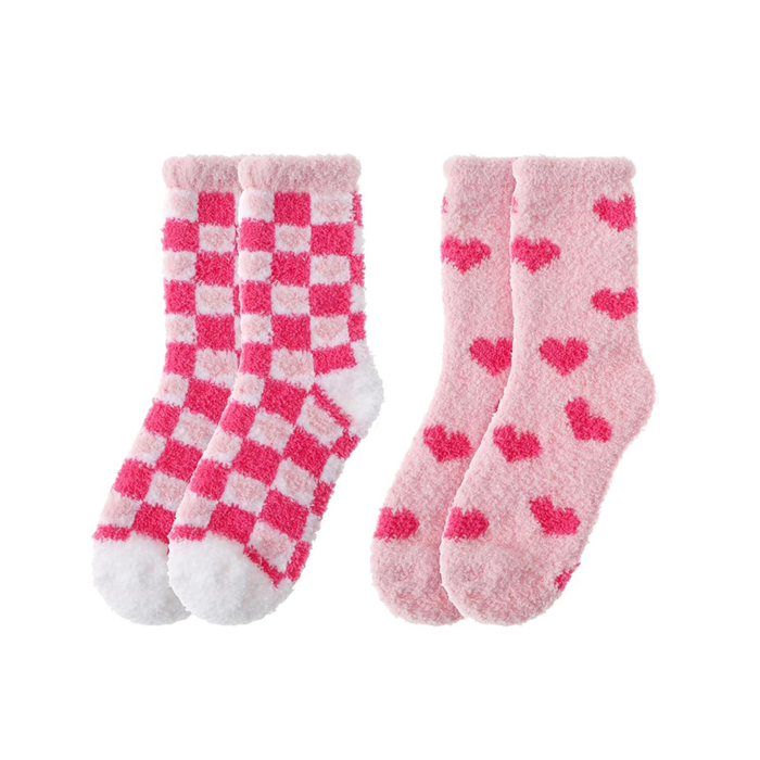 Two pairs of pink socks with checkered and heart patterns on a white background