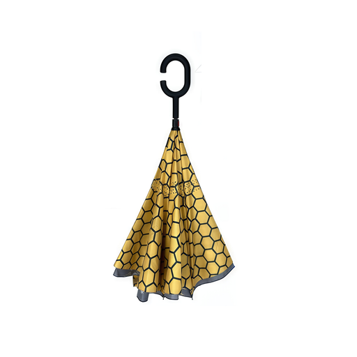 Yellow hexagonal patterned umbrella with a black handle on a white background
