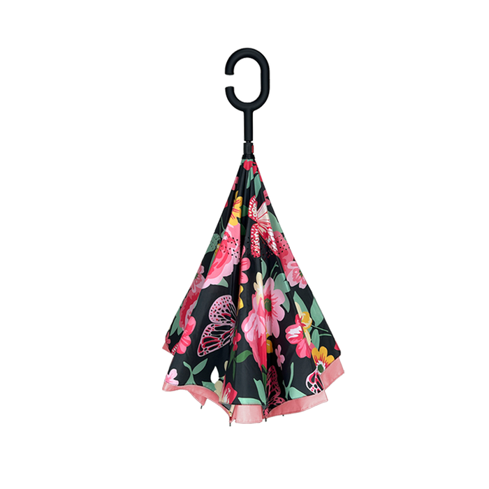 Floral-patterned umbrella with a black handle on a white background